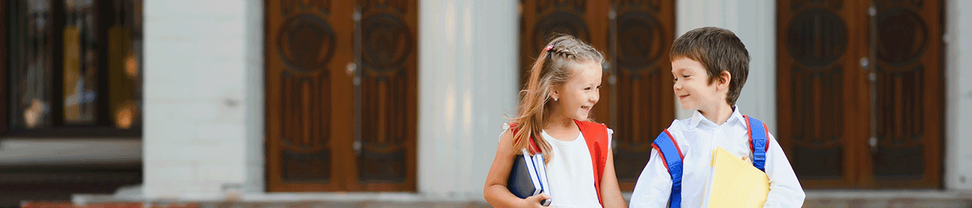 boy-and-girl school aged boy and girl wearing backpacks and looking at each other